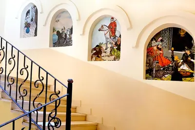 a staircase with stained glass windows in a church at Hotel Sheherazade Luxor in Luxor