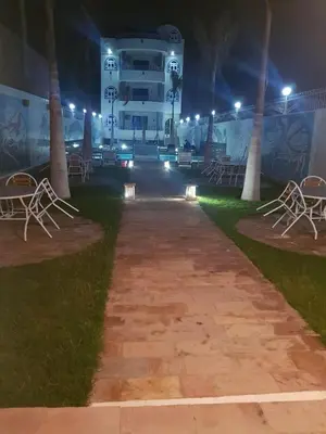a walkway in front of a building at night at Moon Valley Apartments in Luxor