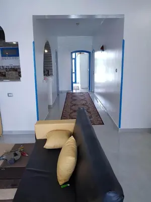 a living room with a couch and a hallway at Moon Valley Apartments in Luxor
