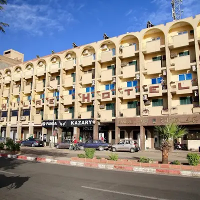 a large building with cars parked in front of it at Philae Hotel Aswan in Aswan