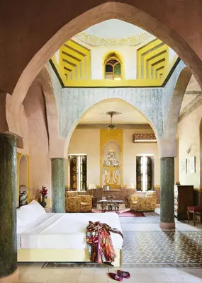 a large living room with a white couch in a room at Al Moudira Hotel in Luxor