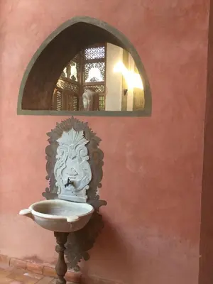 a bathroom with a sink in a wall with a mirror at Al Moudira Hotel in Luxor
