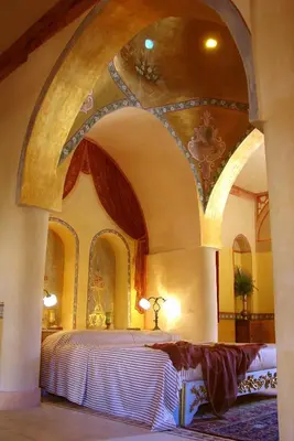 a bedroom with a large bed with an arched ceiling at Al Moudira Hotel in Luxor