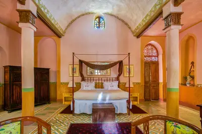 a bedroom with a bed in a large room at Al Moudira Hotel in Luxor