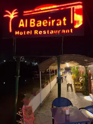 a sign for a hotel restaurant at night at Al Baeirat Hotel in Luxor