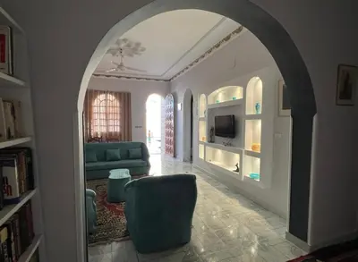 an archway in a living room with a couch and a tv at Al Gezera Apartments in Luxor