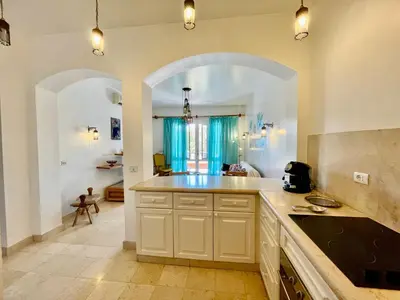 a kitchen with a large counter and an archway at South Marina El Gouna 1 BR in Hurghada
