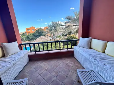 a balcony with couches and a view of the ocean at South Marina El Gouna 1 BR in Hurghada