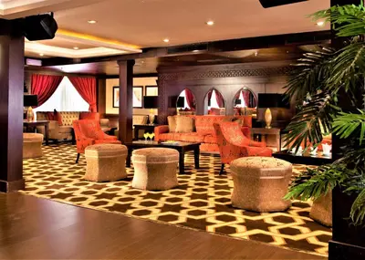 a lobby with orange chairs and tables in a hotel at Steigenberger Legacy Nile Cruise - Every Monday 07 & 04 Nights from Luxor - Every Friday 03 Nights from Aswan in Luxor