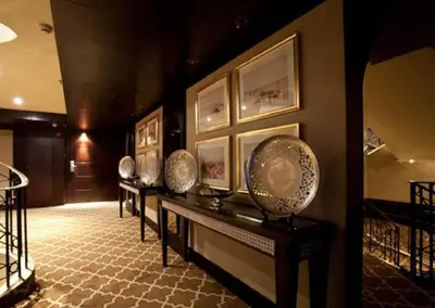 a hallway with a row of plates on a wall at Steigenberger Legacy Nile Cruise - Every Monday 07 & 04 Nights from Luxor - Every Friday 03 Nights from Aswan in Luxor