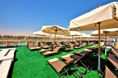a row of chairs and umbrellas on a deck at Steigenberger Legacy Nile Cruise - Every Monday 07 & 04 Nights from Luxor - Every Friday 03 Nights from Aswan in Luxor