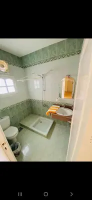 a bathroom with a sink and a toilet and a mirror at Leyla Eco Resort in Luxor