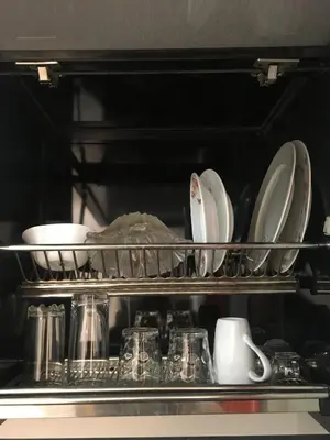a shelf filled with plates and dishes in a microwave at Pool View One bedroom Apt - B103 in Hurghada