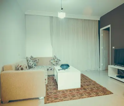 a living room with a couch and a tv at Pool View One bedroom Apt - B103 in Hurghada