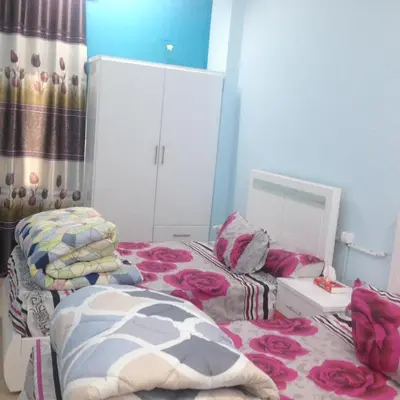 a bedroom with two twin beds and a mirror at Sweet Home Flat 2- 24 Hour open in Hurghada
