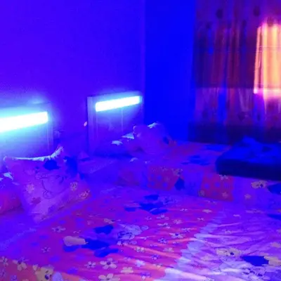 a room with a bed with purple and blue lights at Sweet Home Flat 2- 24 Hour open in Hurghada
