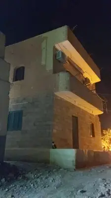a brick building with a beam on it at night at King Nubian House in Aswan