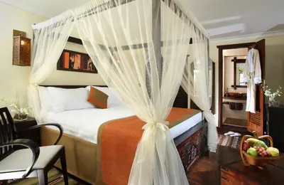 a bedroom with a bed with a canopy at Sonesta Dahabeya Amirat I - Nile Cruise Ship From Luxor to Aswan 7 nights in Luxor