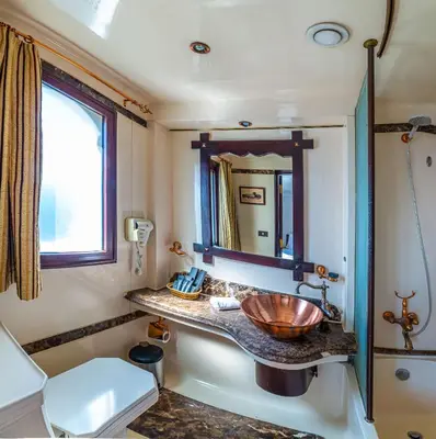 a bathroom with a sink and a mirror at Sonesta Dahabeya Amirat I - Nile Cruise Ship From Luxor to Aswan 7 nights in Luxor