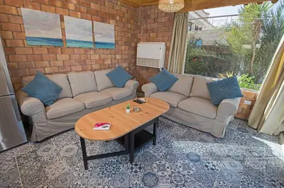 a living room with a couch and a table at One Bedroom Chalet managed by Lilly Homes in Hurghada