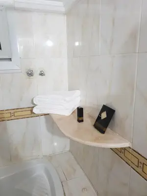 a bathroom with a toilet and a shelf with towels at One Bedroom Chalet managed by Lilly Homes in Hurghada