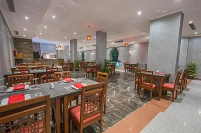 a dining room with tables and chairs in a restaurant at Sunrise Aqua Joy Resort in Hurghada