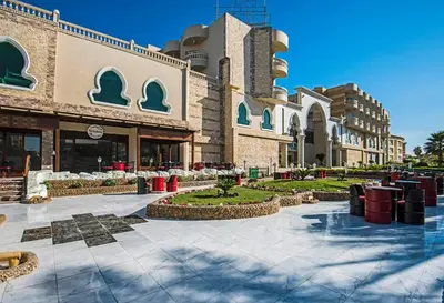 a building with a courtyard with tables and chairs at Sunrise Aqua Joy Resort in Hurghada