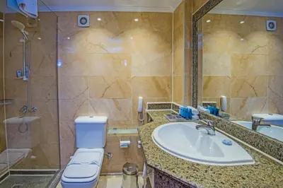 a bathroom with a sink and a toilet and a shower at Sunrise Aqua Joy Resort in Hurghada
