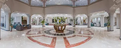 a lobby with a fountain in the middle of a building at Sunrise Aqua Joy Resort in Hurghada