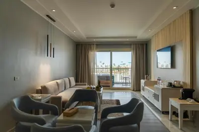 a living room with a couch and a table at Sunrise Crystal Bay Resort -Grand Select in Hurghada