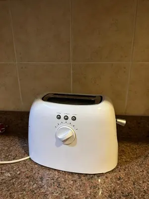 a white toaster sitting on top of a counter at Harmony House Luxor in Luxor
