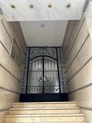 a black gate in a building with stairs at Harmony House Luxor in Luxor