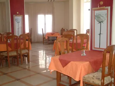 a dining room with tables and chairs with red table cloth at Diana Hotel Hurghada in Hurghada