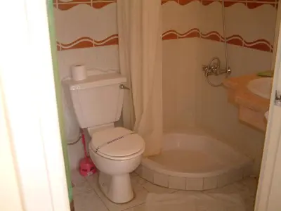 a bathroom with a toilet and a tub and a sink at Diana Hotel Hurghada in Hurghada