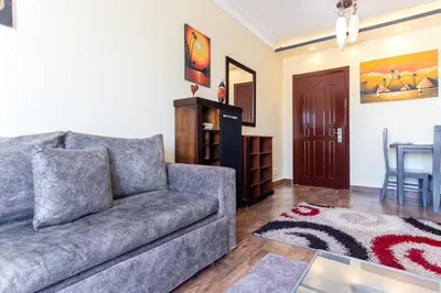 a living room with a couch and a table at Nubian Village Sky, Hurghada in Hurghada