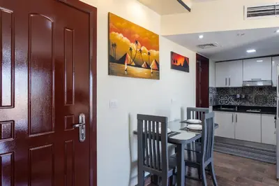 a kitchen and dining room with a table and chairs at Nubian Village Sky, Hurghada in Hurghada