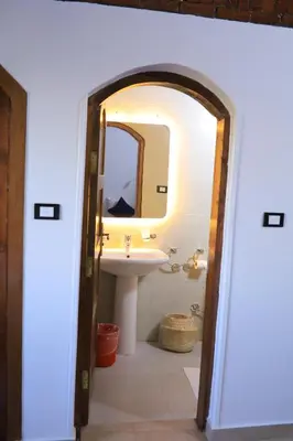 a bathroom with a sink and a mirror at Nubian Holiday House Aswan in Aswan
