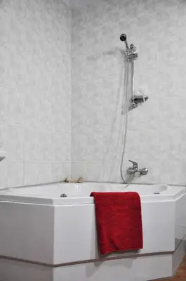 a bathroom with a bath tub with a red towel at Nubian Holiday House Aswan in Aswan