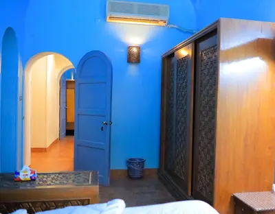 a room with blue walls and a blue door at Nubian Holiday House Aswan in Aswan