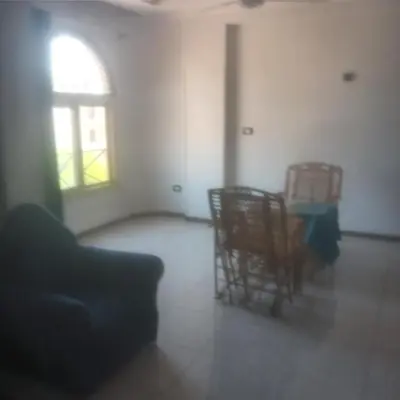 an empty living room with chairs and a window at Memnoun house in Luxor