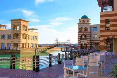 a view of a bridge over a river with tables and chairs at Marina Residence Suites Port Ghalib in Port Ghalib