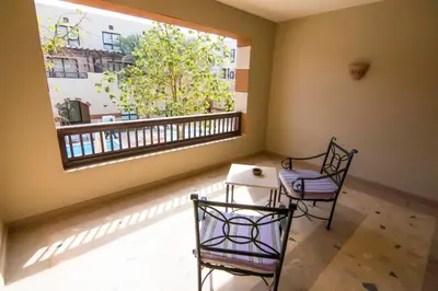 a room with a table and two chairs and a window at Marina Residence Suites Port Ghalib in Port Ghalib