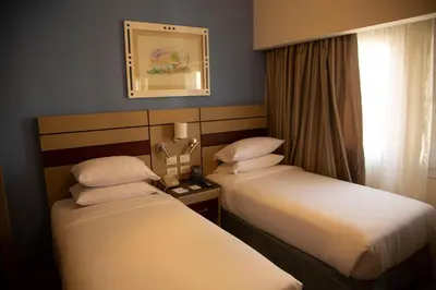 a hotel room with two beds and a window at Swiss Inn Resort Hurghada in Hurghada