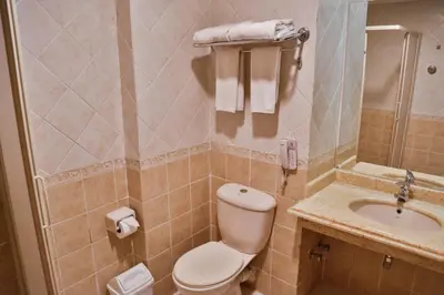 a bathroom with a toilet and a sink at Magic Beach Hotel Hurghada in Hurghada