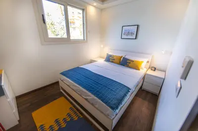 a small bedroom with a bed and a window at Anakob in Aswan
