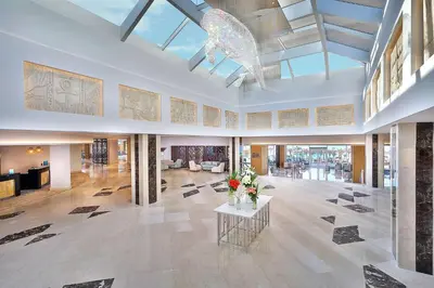 a large lobby with flowers on a table at Hilton Hurghada Plaza Hotel in Hurghada