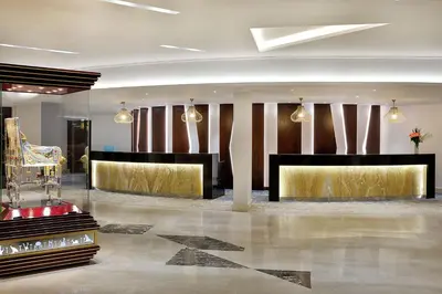 a lobby with a gold and black lobby at Hilton Hurghada Plaza Hotel in Hurghada
