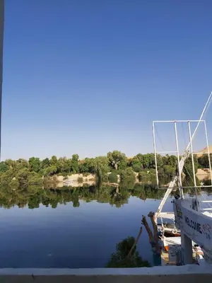 a boat is docked at a dock in a lake at Otasho Nile view house in Aswan