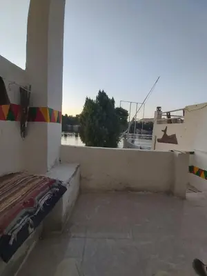 a room with a bed on top of a building at Otasho Nile view house in Aswan
