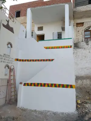 a white wall with a ramp in front of a building at Otasho Nile view house in Aswan